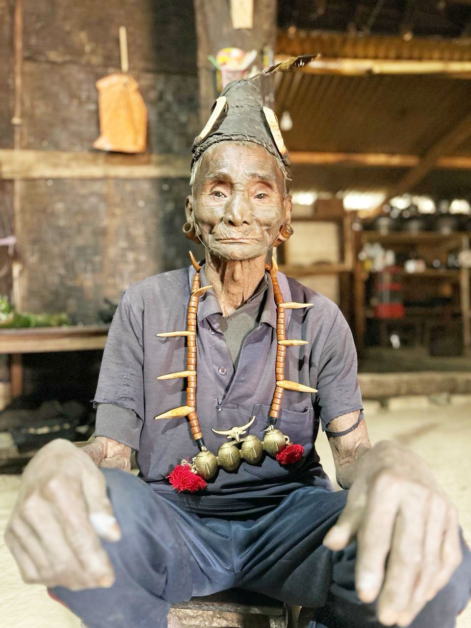 One of the last generations of surviving tattooed headhunters of Longwa village in Mon district, strikes a pose for the camera. Longwa is the largest villages of Mon district in Nagaland and located on the border with Myanmar.  (Morung Photo)